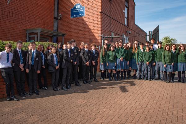 A photo of the Spanish students and KSA students stood together outside of our conference room on a sunny day.
