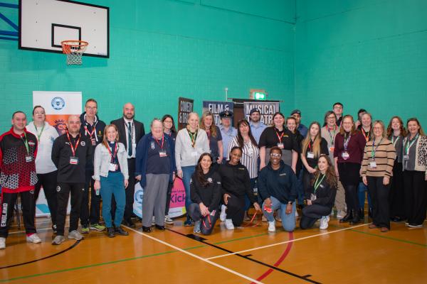 Photo of all of the exhibitors stood together in the school sports hall.